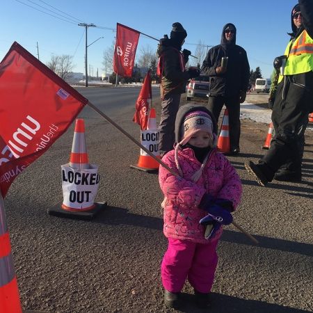 Little girl holding Unifor flag