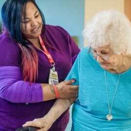 long-term care working helping elderly lady