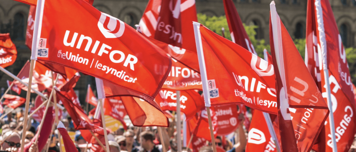 Crowd of people holding Unifor flags